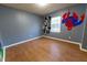 bedroom with wood-look floors and murals at 6006 Nw 62Nd Pl, Ocala, FL 34482