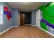 bedroom with wood-look floors and murals at 6006 Nw 62Nd Pl, Ocala, FL 34482