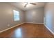 Simple bedroom with wood-look floors and a ceiling fan at 6006 Nw 62Nd Pl, Ocala, FL 34482