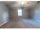 Bedroom with carpeted floor, ceiling fan, and window at 6006 Nw 62Nd Pl, Ocala, FL 34482