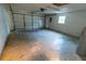 Empty garage with white overhead door and concrete floor at 6006 Nw 62Nd Pl, Ocala, FL 34482