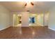 Open living room with kitchen access and wood-look floors at 6006 Nw 62Nd Pl, Ocala, FL 34482