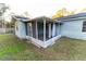 Screened porch with metal frame and curtains at 6006 Nw 62Nd Pl, Ocala, FL 34482