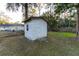 Small white shed in backyard with single window and door at 6006 Nw 62Nd Pl, Ocala, FL 34482