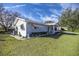 Light blue ranch home with well-manicured lawn at 6460 Sw 111Th St, Ocala, FL 34476