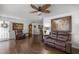 Relaxing living room with leather reclining furniture and hardwood floors at 6460 Sw 111Th St, Ocala, FL 34476