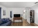 Living room with a TV, console table, and hardwood floors at 6460 Sw 111Th St, Ocala, FL 34476