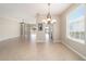 Dining room with tile flooring, chandelier and view to living area at 6716 Sw 91St Cir, Ocala, FL 34481