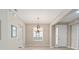 Elegant dining room with chandelier and view of entryway and kitchen at 6716 Sw 91St Cir, Ocala, FL 34481