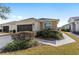 Side view of a single-story house with a two-car garage and landscaped walkway at 6716 Sw 91St Cir, Ocala, FL 34481