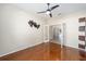 Home office featuring hardwood floors, ceiling fan and built-in shelving at 6716 Sw 91St Cir, Ocala, FL 34481