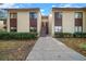 Two-story building with brown accents and stairs leading to entrance at 749 Midway Dr # A, Ocala, FL 34472