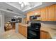 Kitchen with light wood cabinets and view into living room at 749 Midway Dr # A, Ocala, FL 34472