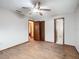 Bedroom with wood floors, ceiling fan and access to bathroom at 7567 Sw 108Th Pl, Ocala, FL 34476