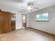 Bedroom with wood floors, ceiling fan, and en-suite bathroom at 7567 Sw 108Th Pl, Ocala, FL 34476