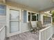 Inviting front porch with two chairs and a view of the yard at 7567 Sw 108Th Pl, Ocala, FL 34476