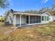 Rear view of house showing screened porch and landscaping at 7567 Sw 108Th Pl, Ocala, FL 34476