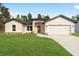 Newly built single-story house with a two-car garage and grassy yard at 7747 Sw 146Th Lane Rd, Ocala, FL 34473