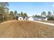 A wide shot of two, single story homes with bright white exteriors, two car garages and freshly landscaped yards at 7747 Sw 146Th Lane Rd, Ocala, FL 34473