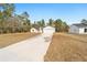 Single-story house with a two-car garage, and a large yard at 7747 Sw 146Th Lane Rd, Ocala, FL 34473