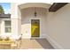 Inviting front entrance with a stylish yellow door at 7747 Sw 146Th Lane Rd, Ocala, FL 34473