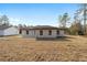 Back of house showing single-story home, backyard, and neighbor's house at 7747 Sw 146Th Lane Rd, Ocala, FL 34473