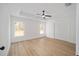 This main bedroom has wood floors, white walls, and a ceiling fan at 7747 Sw 146Th Lane Rd, Ocala, FL 34473