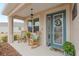 Inviting front porch with rocking chairs and a teal door at 7838 Sw 85Th Cir, Ocala, FL 34481