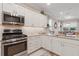 Modern kitchen with stainless steel appliances and white cabinets at 7838 Sw 85Th Cir, Ocala, FL 34481