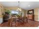 Bright dining room featuring a rustic wooden table and tile floors at 8250 Nw 136Th Avenue Rd, Ocala, FL 34482