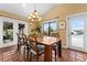 Dining room with a wooden table, tile floors, and sliding glass doors at 8250 Nw 136Th Avenue Rd, Ocala, FL 34482