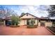 Front view of a ranch-style home with a long driveway and landscaping at 8250 Nw 136Th Avenue Rd, Ocala, FL 34482