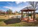 Gazebo with stone seating near a pond at 8250 Nw 136Th Avenue Rd, Ocala, FL 34482