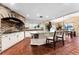 Spacious kitchen with an island, brick accent wall, and white cabinets at 8250 Nw 136Th Avenue Rd, Ocala, FL 34482