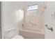 Bathroom featuring a bathtub with shower, a window for natural light, and safety bars at 8535 Sw 82Nd Ter, Ocala, FL 34481