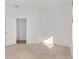 Empty bedroom features carpet floor, bright wall and a view to hallway at 8535 Sw 82Nd Ter, Ocala, FL 34481