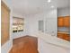 Dining area with a view of the breakfast bar, light hardwood floors, and natural window coverings at 8535 Sw 82Nd Ter, Ocala, FL 34481