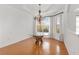 Bright dining area featuring a unique glass-top table with wood base, hardwood floors, and chandelier lighting at 8535 Sw 82Nd Ter, Ocala, FL 34481