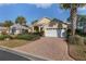 Inviting single-Gathering home with a brick driveway, two-car garage, and beautiful landscaping at 8535 Sw 82Nd Ter, Ocala, FL 34481