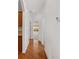 Bright hallway features hardwood floor and view to bedroom at 8535 Sw 82Nd Ter, Ocala, FL 34481