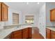 Eat-in kitchen features stainless steel dishwasher, double sink, and wood floors leading to dining area at 8535 Sw 82Nd Ter, Ocala, FL 34481