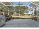 View of screened patio with a stainless steel gas grill and a view of the lawn at 8535 Sw 82Nd Ter, Ocala, FL 34481