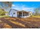 White house exterior with screened porch and autumn leaves at 8890 Sw 96Th St # D, Ocala, FL 34481