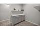 Bright laundry room with double sink and upper shelving at 891 Nw 44Th Street Rd, Ocala, FL 34475