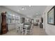 Dining room with a wooden table and bench, kitchen view, and hardwood floors at 8958 Sw 57Th Place Rd, Ocala, FL 34481