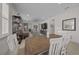 Bright dining room with wooden table and view into the living room at 8958 Sw 57Th Place Rd, Ocala, FL 34481