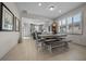 Dining room with a wooden table and bench, kitchen view, and hardwood floors at 8958 Sw 57Th Place Rd, Ocala, FL 34481