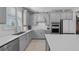 Bright kitchen with white subway tile backsplash and gray cabinetry at 8958 Sw 57Th Place Rd, Ocala, FL 34481