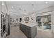 Modern kitchen with island, gray cabinets and a view of the backyard patio at 8958 Sw 57Th Place Rd, Ocala, FL 34481