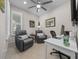 Home office with two recliner chairs, a desk, and a large window at 8958 Sw 57Th Place Rd, Ocala, FL 34481